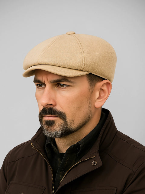 Boina masculina bege claro no estilo italiano clássico, usada por modelo masculino com jaqueta marrom escura

